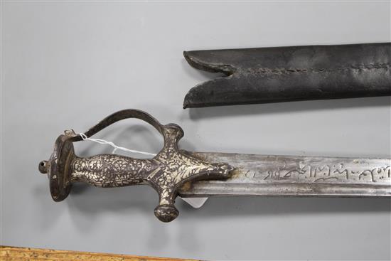 An Indian sword tulwar, silver decorated iron Lahori hilt, blade with etched inscription, 18th century, leather covered scabbard,